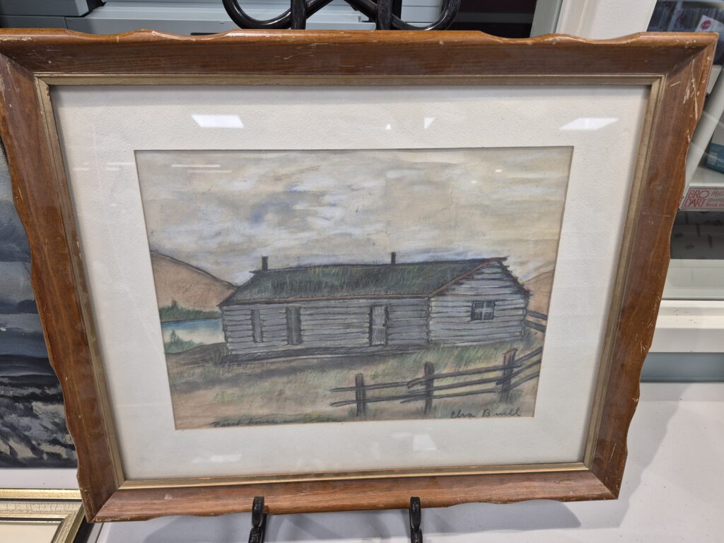 Hand-drawn picture of a wood house. "First House - Polson" by E. Buell