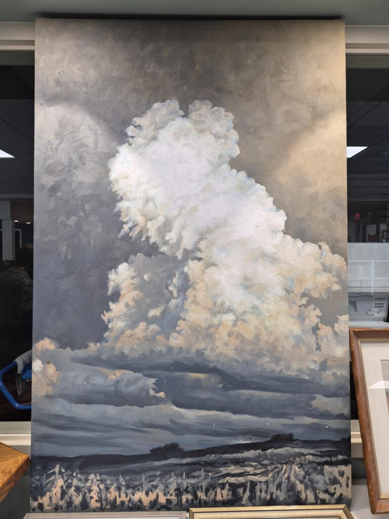 Large canvas painting of a storm cloud over a field